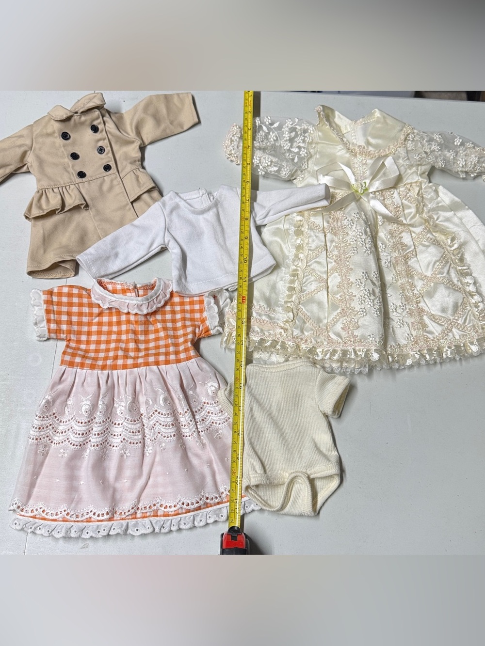 Ivory tone doll dress with other clothes and dress bundle